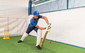 A student of SIS practicing cricket