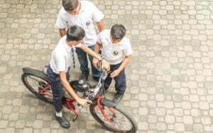 Student of SIS riding a push cycle