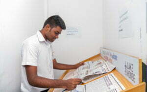 A student of SIS reading a newspaper