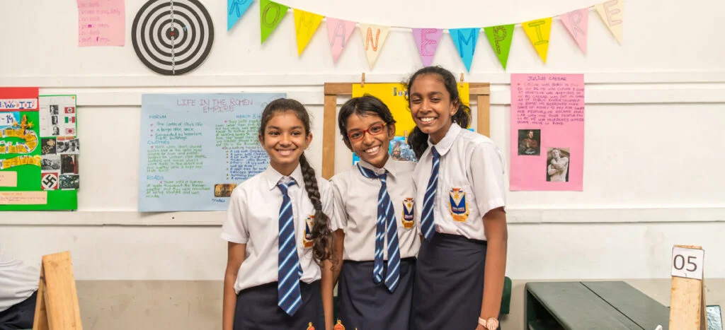 Students of SIS smiling at the camera